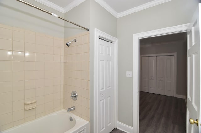 bathroom with crown molding, hardwood / wood-style floors, and tiled shower / bath combo