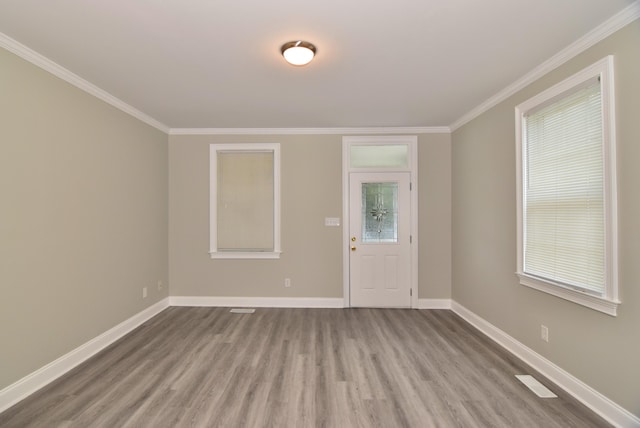 entrance foyer featuring light hardwood / wood-style floors and ornamental molding