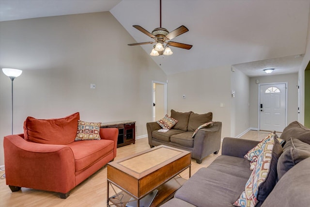 living room featuring ceiling fan, high vaulted ceiling, and light hardwood / wood-style flooring