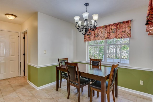 dining space featuring tile patterned floors and a chandelier