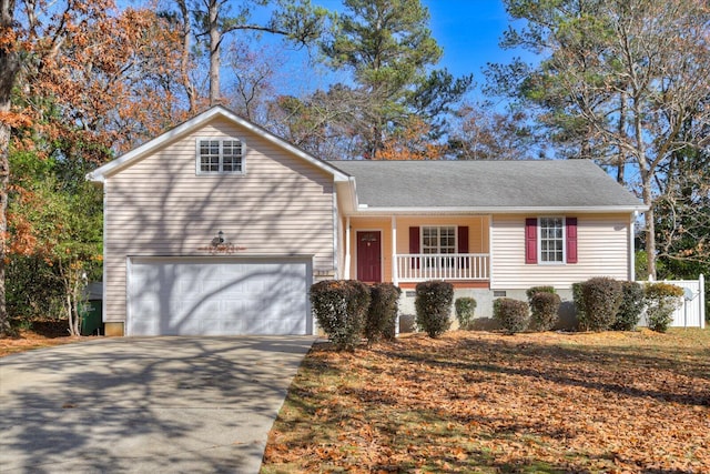 ranch-style home with covered porch and a garage