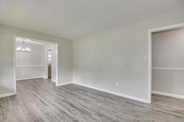 3609 Fairfax Ct, Augusta, GA 30906 - unfurnished bedroom with a chandelier, wood finished floors, and baseboards