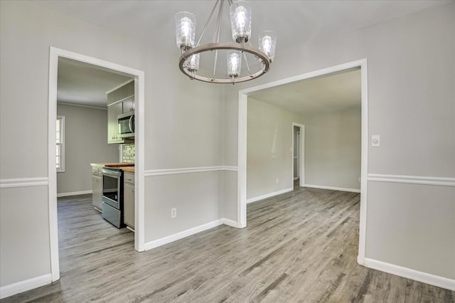3609 Fairfax Ct, Augusta, GA 30906 - empty room featuring a chandelier, wood finished floors, and baseboards