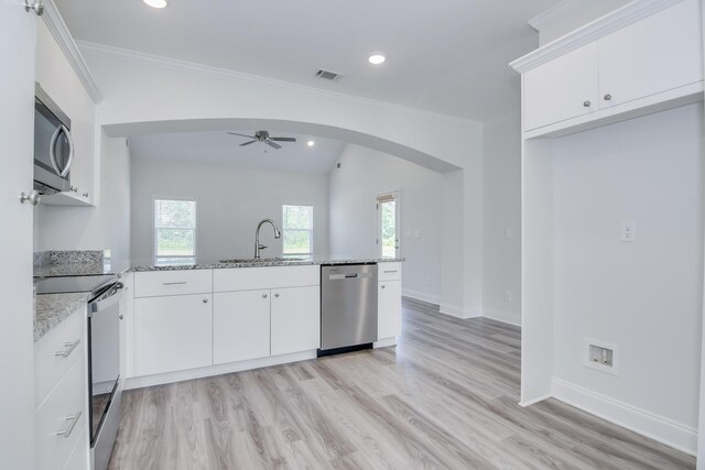 326 Agape Ln, Trenton, SC 29847 - kitchen featuring appliances with stainless steel finishes, arched walkways, a peninsula, a ceiling fan, and healthy amount of natural light