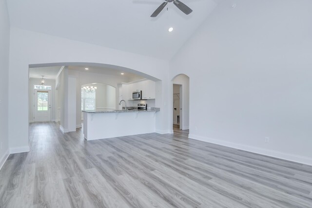 326 Agape Ln, Trenton, SC 29847 - unfurnished living room featuring ceiling fan, light wood-type flooring, a chandelier, recessed lighting, and arched walkways