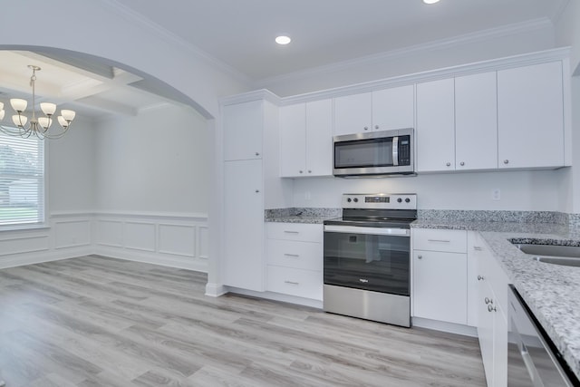 326 Agape Ln, Trenton, SC 29847 - kitchen with stainless steel appliances, arched walkways, a chandelier, ornamental molding, and white cabinetry