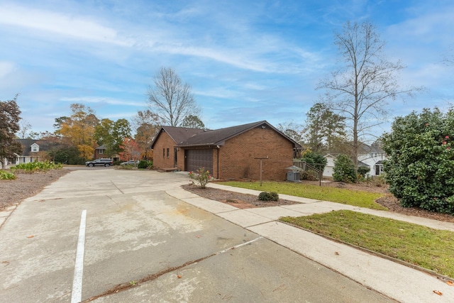 view of front of house featuring a garage and a front lawn