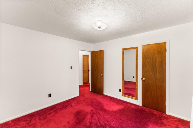 carpeted empty room with a textured ceiling