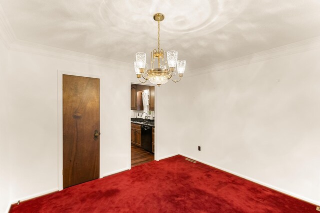 carpeted spare room with sink, a chandelier, and ornamental molding