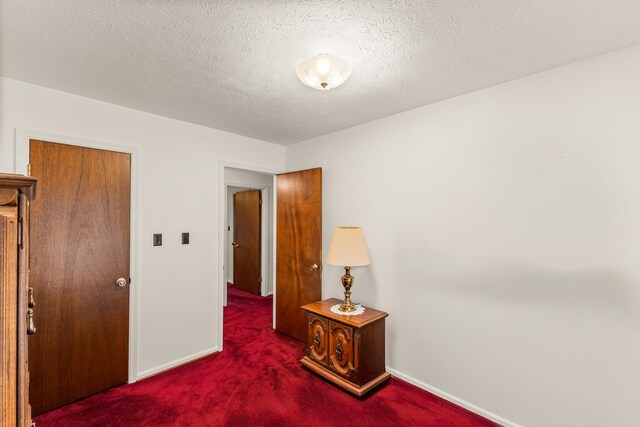 carpeted bedroom featuring a textured ceiling