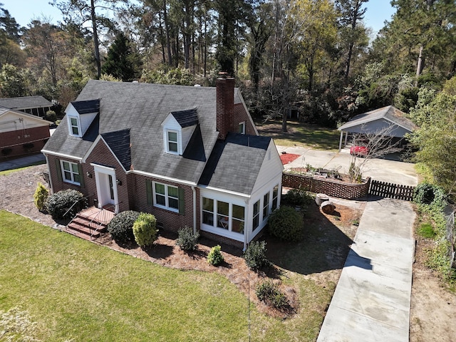 413 Park Dr, Waynesboro, GA 30830 - new england style home featuring fence, roof with shingles, a front yard, brick siding, and a chimney