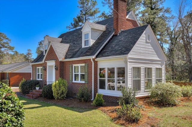 413 Park Dr, Waynesboro, GA 30830 - view of front facade with a front lawn, a chimney, a sunroom, and roof with shingles