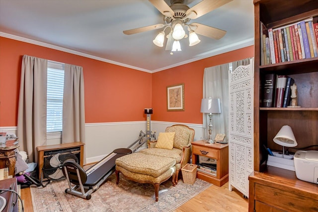 413 Park Dr, Waynesboro, GA 30830 - living area featuring crown molding, wood finished floors, wainscoting, and ceiling fan