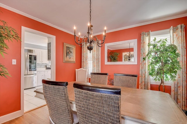 413 Park Dr, Waynesboro, GA 30830 - dining space with an inviting chandelier, crown molding, and light wood-style floors
