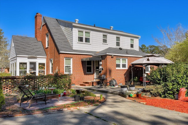 413 Park Dr, Waynesboro, GA 30830 - back of property with brick siding, roof with shingles, a chimney, and a patio area