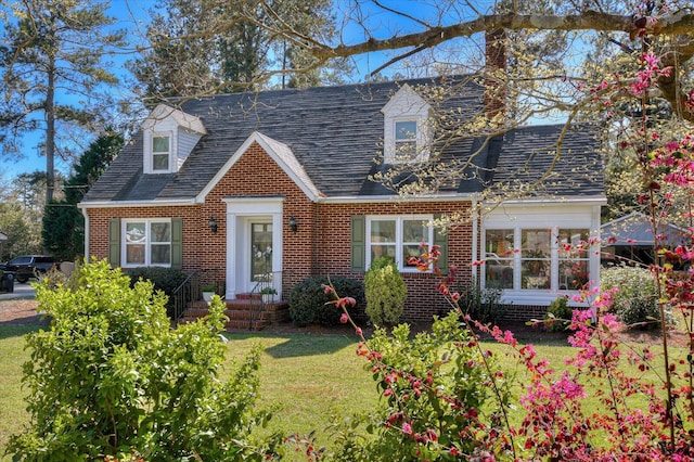 413 Park Dr, Waynesboro, GA 30830 - cape cod house featuring brick siding, a chimney, a front lawn, and roof with shingles
