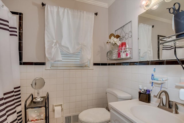 413 Park Dr, Waynesboro, GA 30830 - bathroom featuring visible vents, crown molding, toilet, tile walls, and a sink