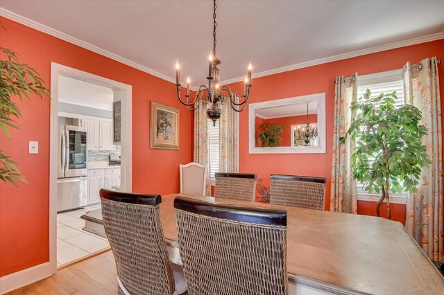 413 Park Dr, Waynesboro, GA 30830 - dining room featuring light wood-style flooring, ornamental molding, and a chandelier