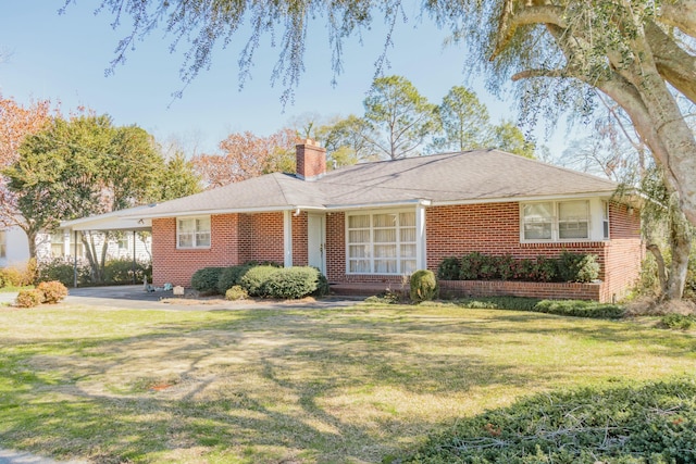 ranch-style house featuring brick siding, a chimney, and a front yard