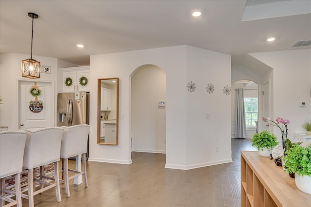 1207 Mary Hill Ct, Evans, GA 30809 - dining area with arched walkways, visible vents, and wood finished floors