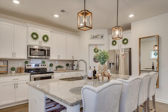 1207 Mary Hill Ct, Evans, GA 30809 - kitchen with visible vents, pendant lighting, a sink, stainless steel appliances, and white cabinetry