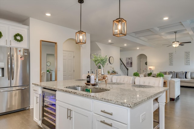 1207 Mary Hill Ct, Evans, GA 30809 - kitchen with a sink, arched walkways, open floor plan, wine cooler, and stainless steel refrigerator with ice dispenser