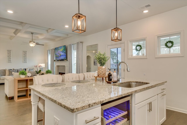 1207 Mary Hill Ct, Evans, GA 30809 - kitchen with a sink, open floor plan, wood finished floors, wine cooler, and visible vents