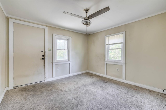 unfurnished room with ceiling fan and carpet