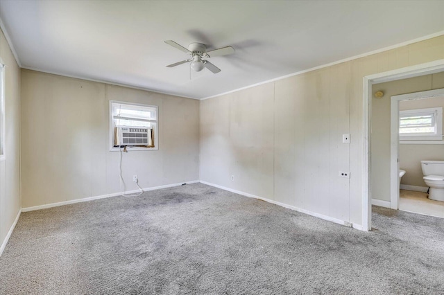 carpeted empty room with ceiling fan, crown molding, and cooling unit