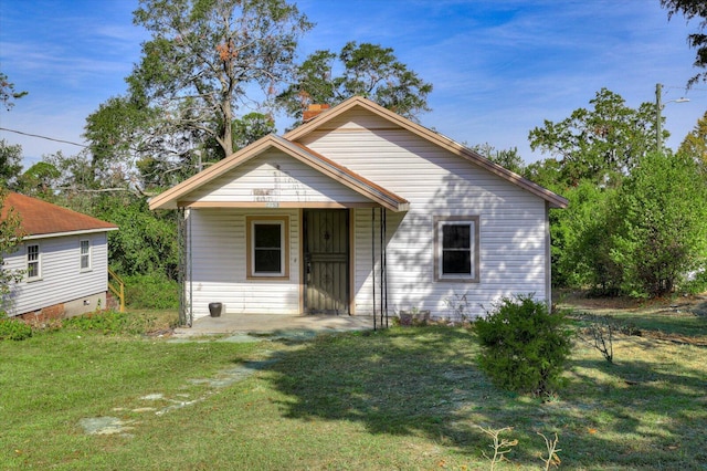 bungalow-style home with a front lawn