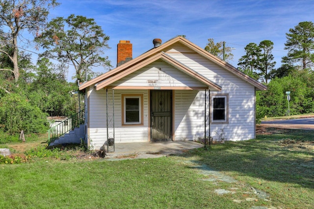 bungalow-style house with a front yard