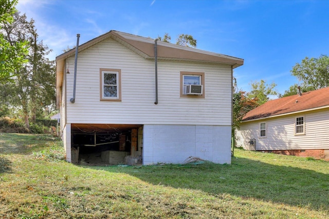 rear view of house with a lawn and cooling unit