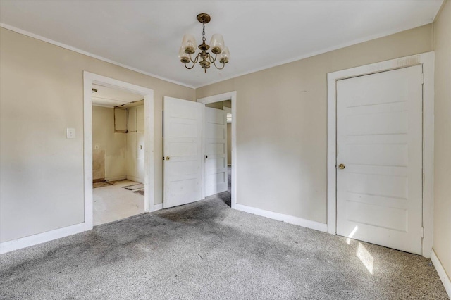 carpeted empty room featuring a chandelier