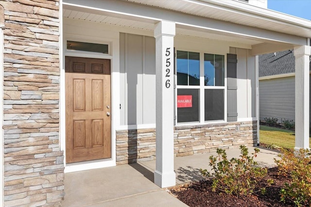 property entrance with stone siding