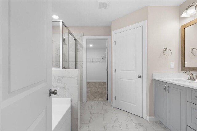 full bath with visible vents, marble finish floor, a walk in closet, vanity, and a shower stall