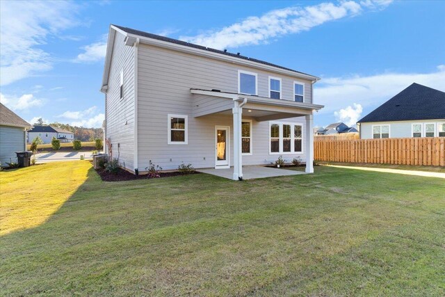 back of house featuring central air condition unit, a patio area, fence, and a yard