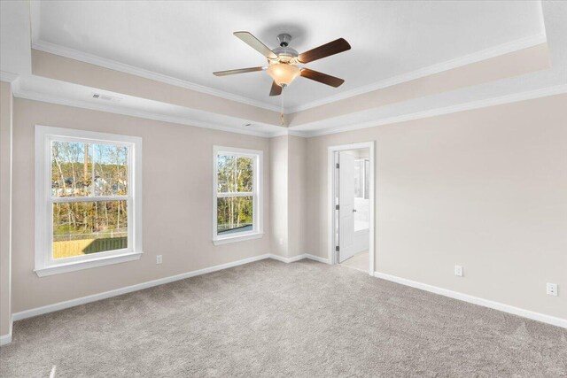 unfurnished room with a ceiling fan, light carpet, crown molding, and baseboards