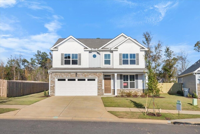 view of front of house with driveway, stone siding, an attached garage, fence, and a front lawn