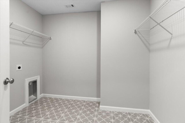 washroom with laundry area, baseboards, visible vents, tile patterned floors, and electric dryer hookup