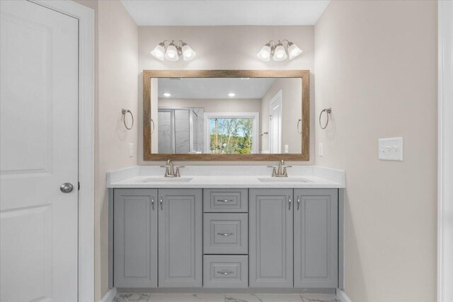 full bathroom featuring a stall shower, a sink, and double vanity