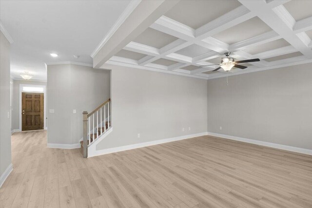 spare room featuring stairs, light wood-type flooring, coffered ceiling, and baseboards