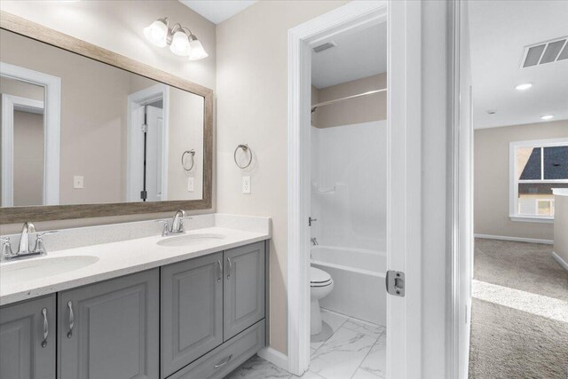 full bathroom featuring toilet, marble finish floor, a sink, and visible vents