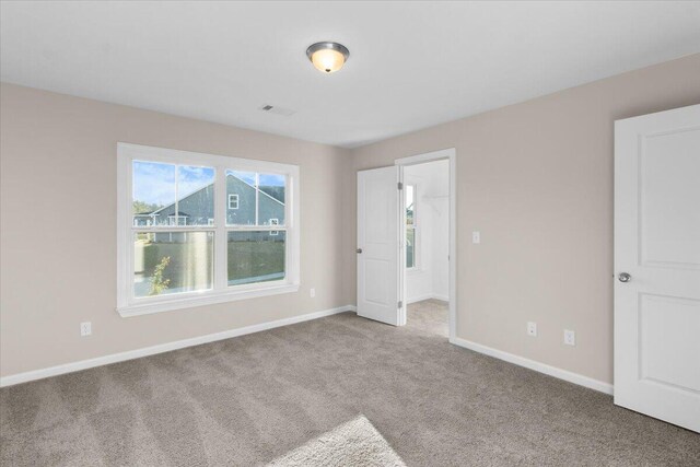 interior space featuring baseboards and light colored carpet