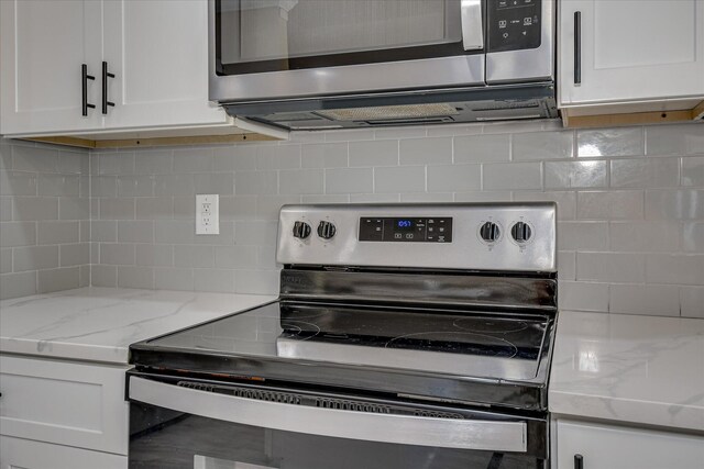 1222 Jessie Way, Augusta, GA 30906 - kitchen with appliances with stainless steel finishes, white cabinets, decorative backsplash, and light stone counters