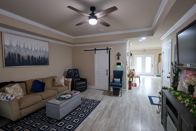 1222 Jessie Way, Augusta, GA 30906 - living room featuring crown molding, a barn door, a raised ceiling, a ceiling fan, and light wood finished floors