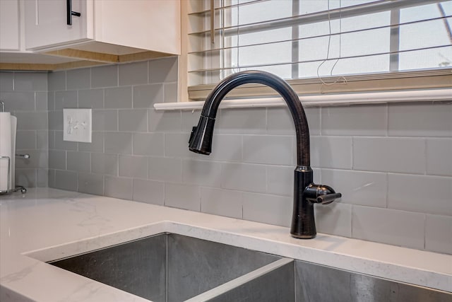 1222 Jessie Way, Augusta, GA 30906 - room details with white cabinetry, light stone counters, decorative backsplash, and a sink