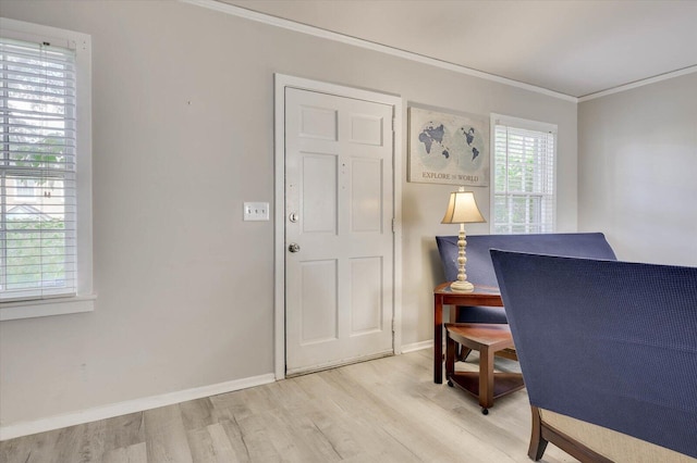 office area with a healthy amount of sunlight, crown molding, and light hardwood / wood-style flooring