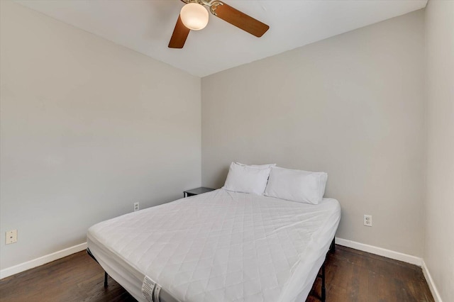 bedroom with ceiling fan and dark hardwood / wood-style floors