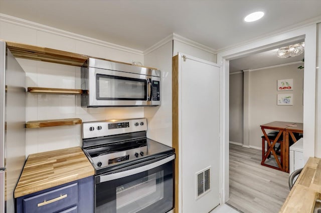 kitchen featuring blue cabinetry, stainless steel appliances, wood counters, light hardwood / wood-style flooring, and ornamental molding