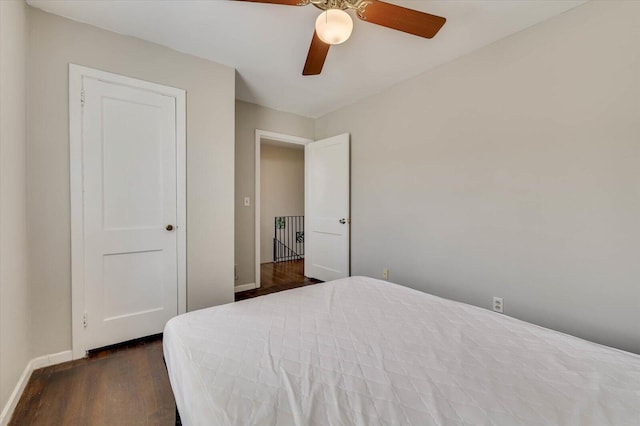 bedroom with ceiling fan and dark wood-type flooring